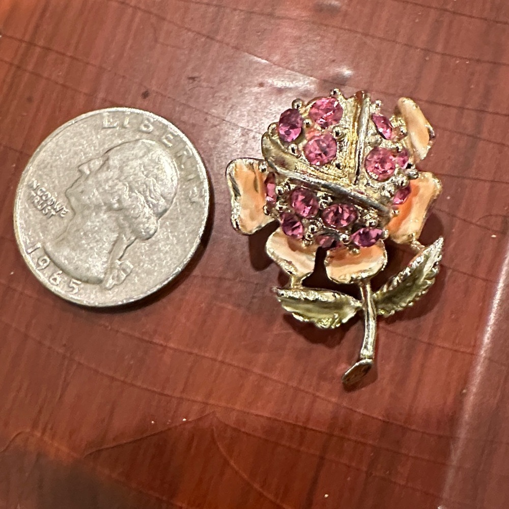 Vintage 1960s pin with pink rhinestone and enamel accents.